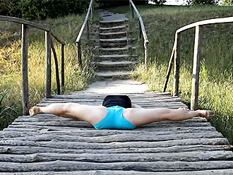 Sexy yoga exercises on a wooden bridge
