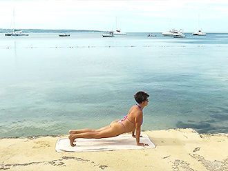 Mature woman does nearly naked yoga workout in public